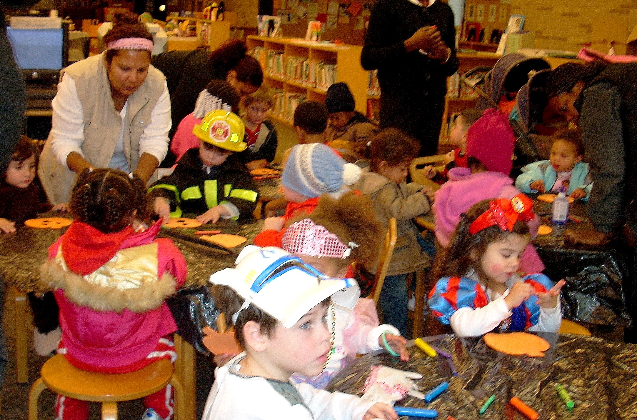 Costumed kids making Halloween craft