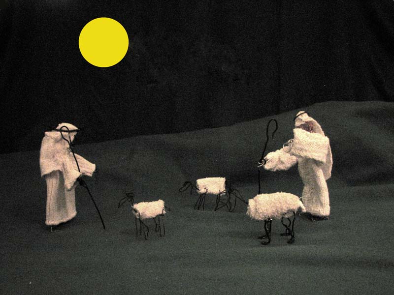 s Yellow moon on a black sky with a black-and-white diorama of wirefram-and-rag_towelling shepherds and sheep.
