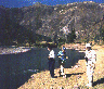 [Snapshot of 3 birders by a lake]